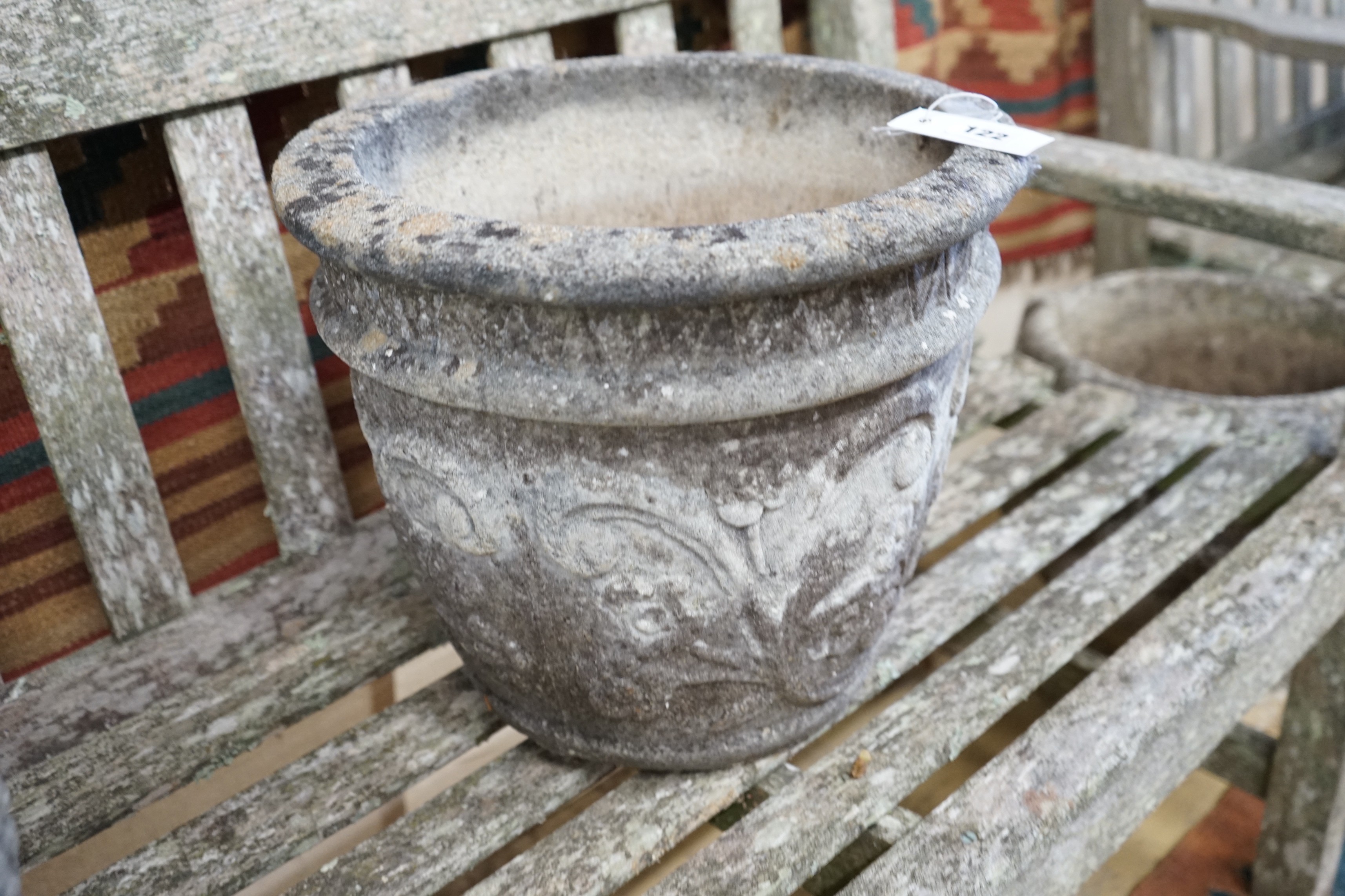 Three circular reconstituted stone garden planters, largest diameter 40cm, height 32cm